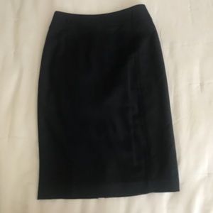 Black pencil skirt with back ruffle detail by Bebe
